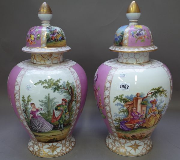 A pair of Dresden style vases and covers, early 20th century, each decorated with a gallant and companion against a foliate gilt and pink baluster gro