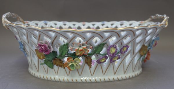 A Dresden porcelain two handled oval basket, early mid-20th century, pierced with applied flowers and gilt heightening, blue printed mark (37cm wide)