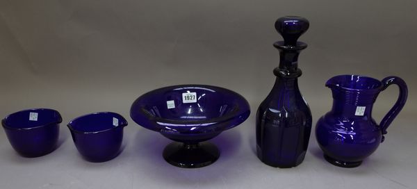 A `Bristol blue' glass footed circular bowl (26cm diameter), four further `Bristol blue' glass items and a glass gin pig (29cm wide) (6)