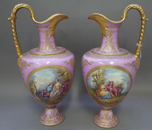 An unusual pair of Copeland porcelain ewers, circa 1870, painted in the French style, each side with two panels of Watteauesque lovers in landscapes,