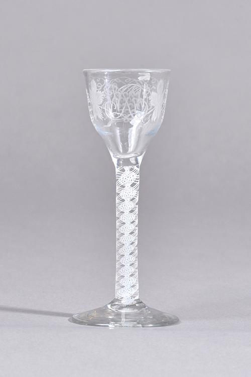 An engraved opaque twist wine glass, circa 1765, the ogee bowl engraved on one side with entwined initials, the reverse engraved with fruiting vine, r