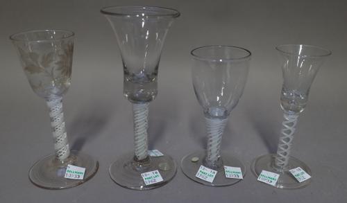 An engraved opaque twist wine glass, circa 1765, the rounded funnel bowl engraved with a flower and insect, raised on a double series opaque twist ste