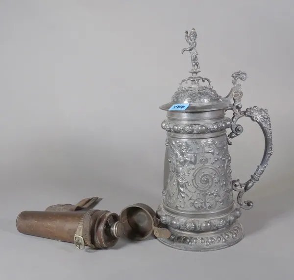 An early 20th century large pewter tankard with acanthus and cherub decoration, 39cm high, two hunting whips and a 20th century hunting flask in a lea