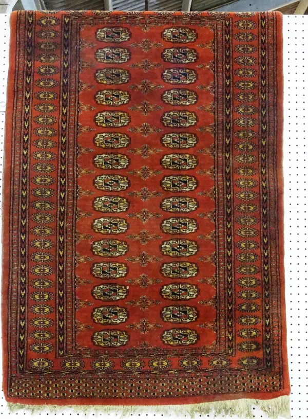 An Indian Bokhara rug, madder field, two columns of fifteen guls, 150cm x 97cm.  J7