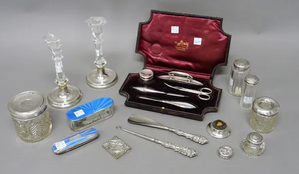 A group of silver mounted mostly dressing table wares, comprising a manicure set, cased, a pair of glass candlesticks (one damaged), a blue enamelled