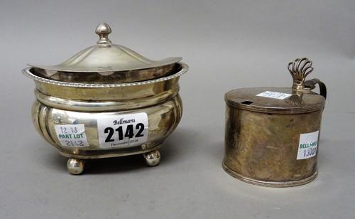 Silver, comprising a hinge lidded tea caddy of compressed oval form, raised on four spherical feet, Birmingham 1919 and a George III hinge lidded must