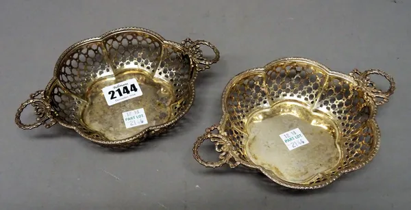 A pair of silver twin handled bonbon dishes, each of hexafoil form, with pierced decoration, the cast handles decorated with bows, Birmingham 1920, co