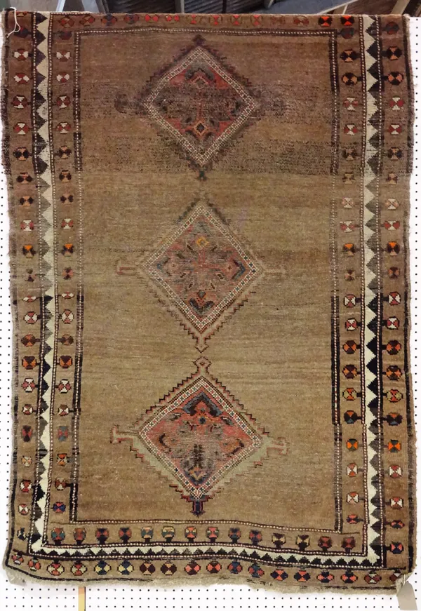 A Gabbeh rug, brown field with three diamonds, 186cm x 123cm.  D4