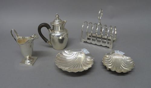 Silver, comprising; a late Victorian small hot water jug, Birmingham 1897, a helmet shaped cream jug, raised on a square base, Birmingham 1908, a butt