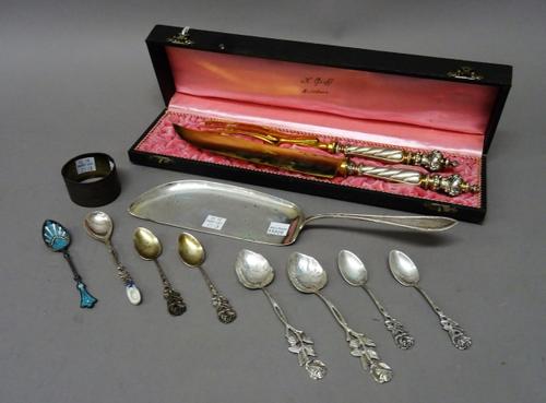 Foreign wares, comprising; a serving slice detailed 800, a French napkin ring, a blue and white enamelled spoon, seven further spoons and a German ser