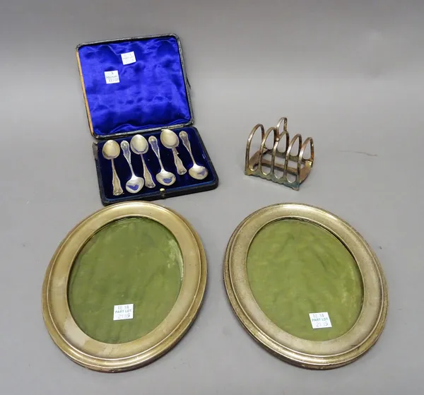 A pair of silver mounted oak oval photograph frames, Birmingham 1911, a set of six silver teaspoons (one broken) London 1902, cased and a plated five