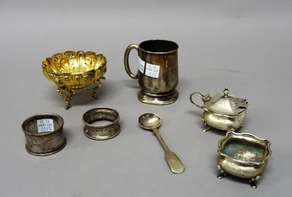 A Victorian silver gilt bonbon bowl of shaped oval form, decorated with mythological masks and raised on three feet, London 1890, a mustard pot with a