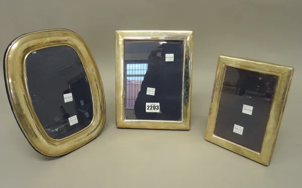 Two silver mounted rectangular photograph frames and a silver mounted curved rectangular photograph frame, all modern, (3).