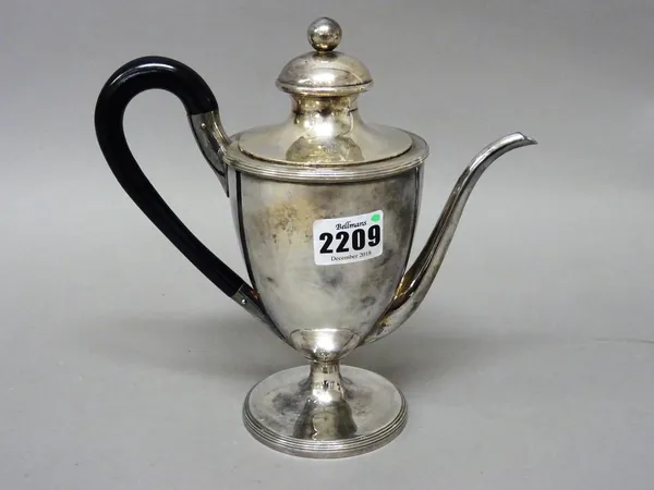 A George III silver Argyle and cover, of urn shaped form with reeded decoration to the rims, with an ebonised handle, the body engraved with a shield,