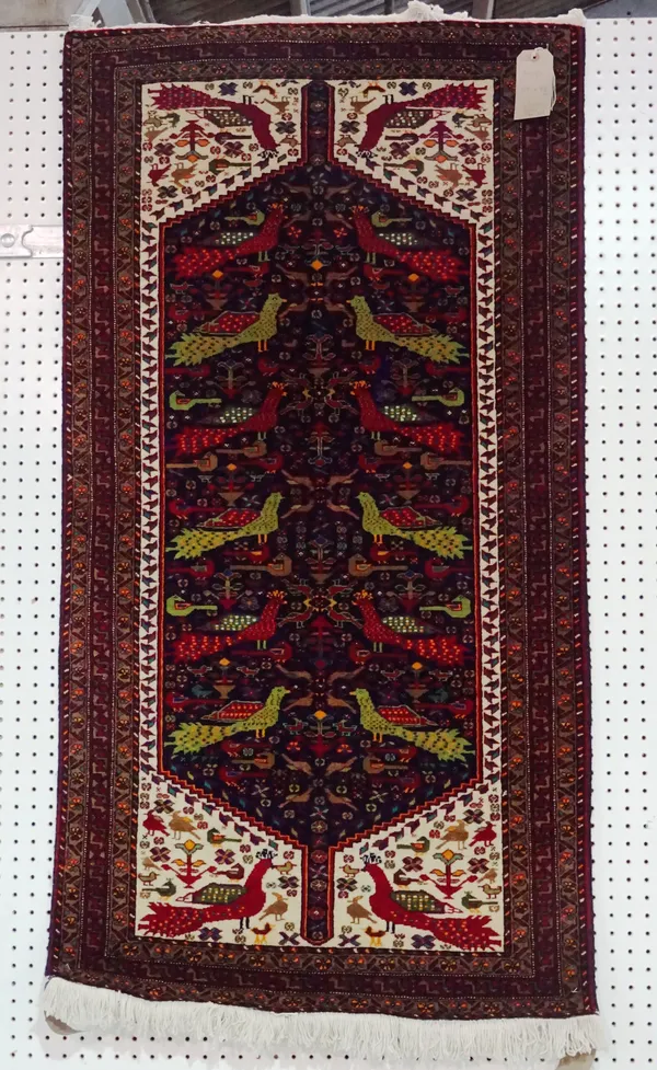 A Caucasian rug, indigo field filled with birds, 147cm x 78cm.  E5