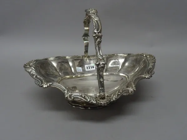 A William IV silver bread or fruit basket, of shaped oval form, the rim and the swingover handle with bold foliate scrolling decoration, with scallop