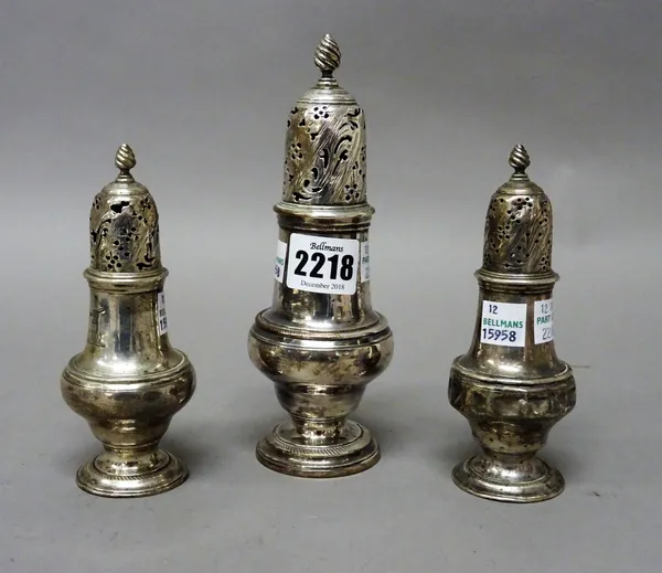 An early George III set of three silver sugar casters, each of inverted pear shaped form, with pierced and engraved decoration to the tops and with Wr