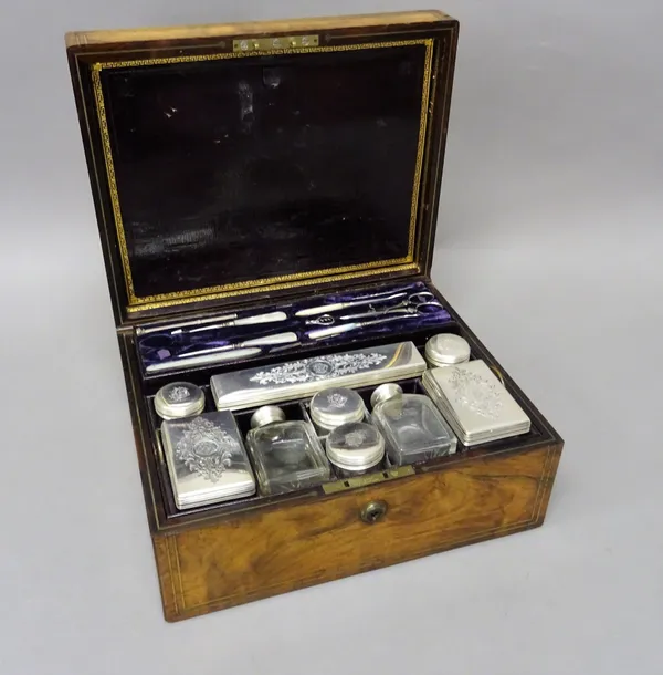 A Victorian rosewood travelling toilet box, fitted with a variety of silver lidded glass toilet boxes, bottles and jars, London 1851 and also various