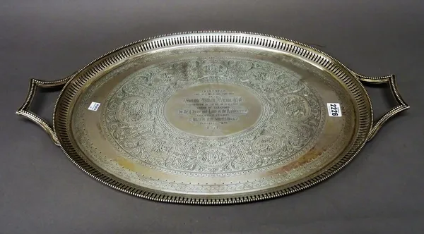 A Victorian silver twin handled oval tray, presentation inscribed to the centre within an engraved surround with a pierced border and beaded rim, Lond