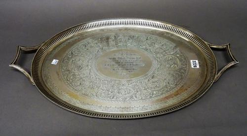 A Victorian silver twin handled oval tray, presentation inscribed to the centre within an engraved surround with a pierced border and beaded rim, Lond