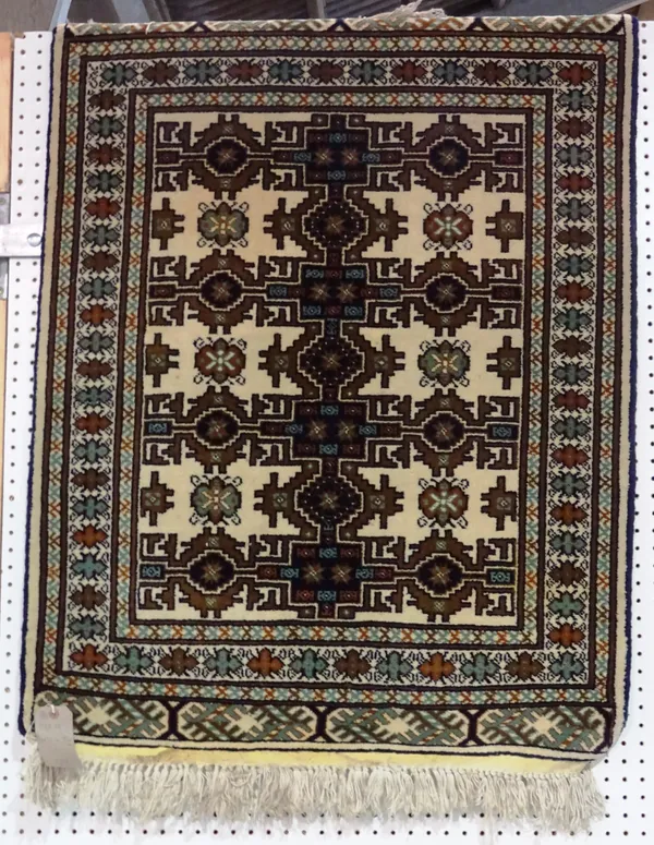 A Persian rug of Caucasian design, six ivory star medallions, 115cm x 86cm.   BAY 1
