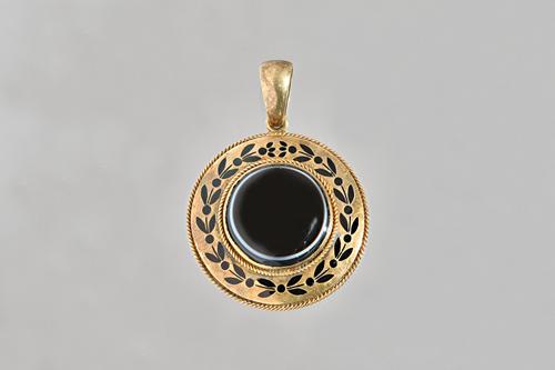 A Victorian gold, banded agate and black enamelled mourning pendant, of circular form, mounted with the banded agate to the centre within a black enam