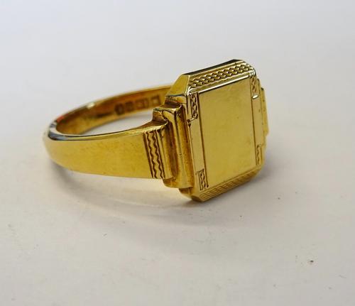 A gentleman's 18ct gold signet ring, of cut cornered rectangular form, partially engine turned, Birmingham 1958, weight 8.3 gms, ring size V, with a c