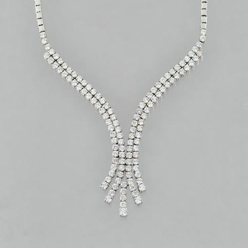 A white gold and diamond set necklace, formed as an articulated symmetrical scroll, mounted with one hundred and seventeen round circular cut diamonds