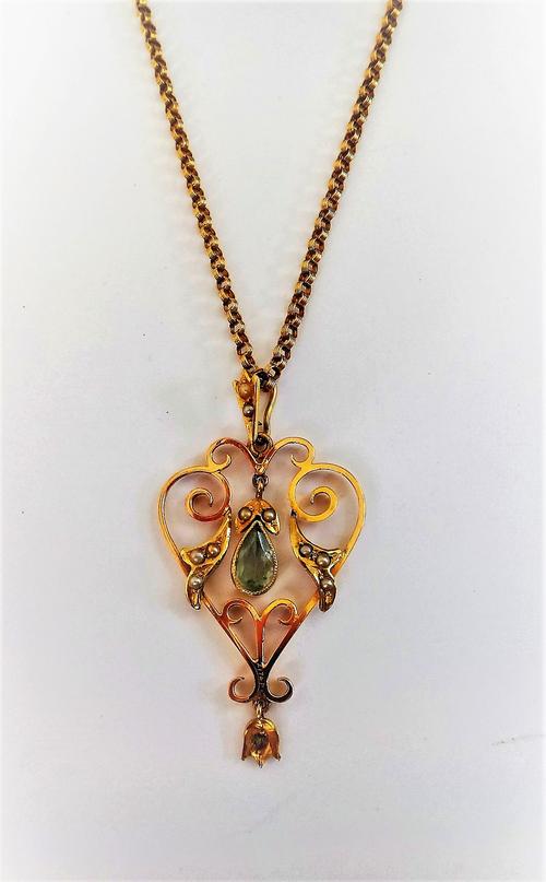 A gold, seed pearl and aquamarine set pendant, in an openwork scrolling design, with a gold ribbed circular link neckchain, on a cylindrical clasp, fi