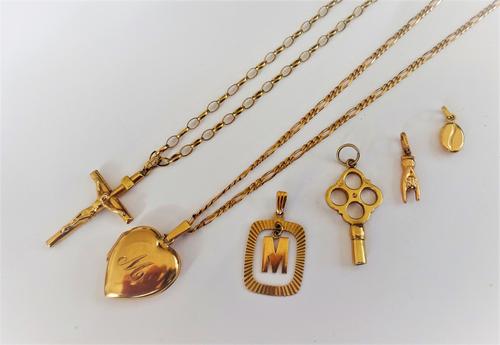 A 9ct gold heart shaped pendant locket, with a 9ct gold neckchain,  a gold pendant crucifix, detailed 9 KT with a 9ct gold oval link neckchain, on a b