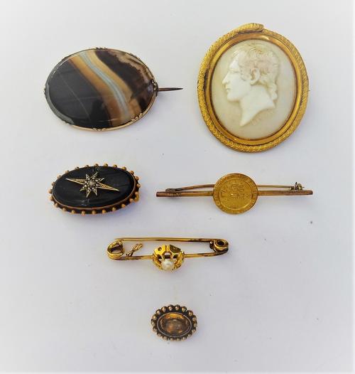 A gold mounted oval shell cameo brooch, carved as the portrait of a gentleman, detailed BANKES within a serpentine surround, a gold mounted oval bande