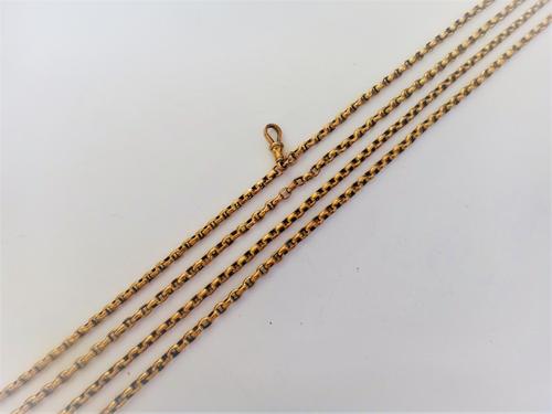 A gold oval link long guard muff chain, detailed 9 CT, fitted with a gold swivel detailed 9 CT, weight 37.8 gms, length 157cm.