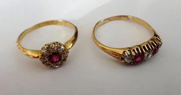 An 18ct gold, ruby and diamond cluster ring, claw set with a cushion shaped ruby in a surround of eight cushion shaped diamonds, Chester probably 1897