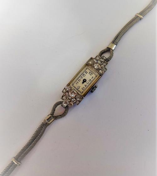 A lady's diamond set rectangular cased dress wristwatch, the jewelled lever movement detailed Normis Watch Co, the case terminals mounted with circula