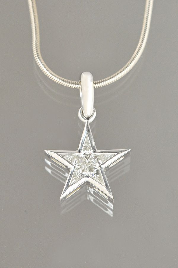 A white gold and diamond set pendant, designed as a five pointed star, mounted with five kite shaped diamonds, detailed 18 K, on an 18ct white gold Br