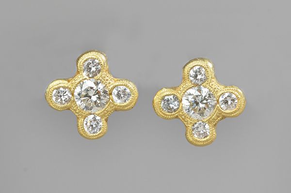 A pair of gold and diamond set five stone earstuds, each mounted with the principal circular cut diamond to the centre, in a surround of four smaller