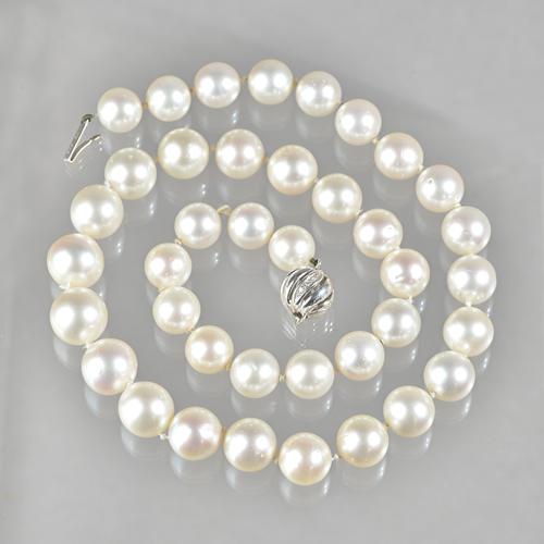 A single row necklace of South Sea cultured pearls, on an 18ct  white gold and diamond set spiral decorated spherical clasp, the thirty-nine cultured