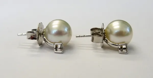 A pair of Mikimoto white gold, cultured pearl and diamond earstuds, each mounted with a cultured pearl above a claw set circular cut diamond, the back