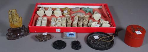 A group of Chinese jade and hardstone carvings, two soapstone carvings of water buffalo and seated figure, a Chinese bronze mirror, a Japanese red lac