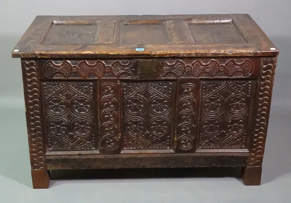 A 18th century and later oak triple panel coffer with carved decoration, 107cm wide x 67cm high.   H5