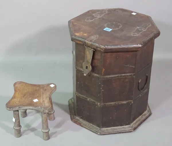 A 20th century Camphor wood and metal bound octagonal lift top box, 38cm wide x 47cm high and an early 20th century primitive stool, 26cm wide x 19cm