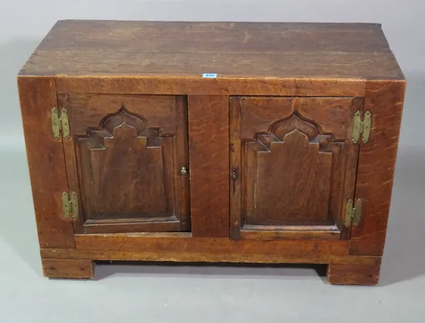 An oak two door cupboard, incorporating 18th century timber, 89cm wide x 59cm high.  H7