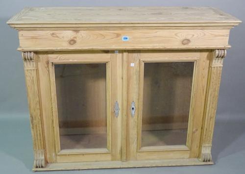 An early 20th century pine side cabinet with fluted edges, 116cm wide x 90cm high and a 20th century stained pine over mantel wall mirror, 75cm wide x