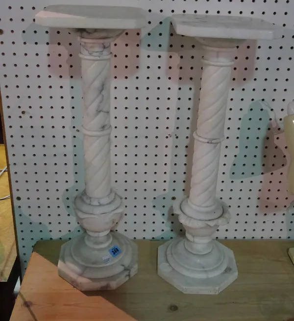 A pair of 20th century white marble columns on octagonal plinth bases, 60cm high (2).   ROST