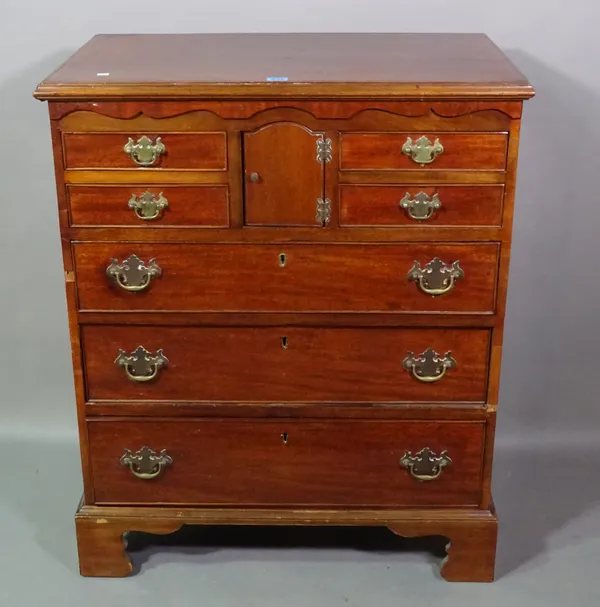An early 19th century mahogany chest of four short drawers, with central cupboard above three graduated drawers on bracket feet, 75cm wide x 71cm high