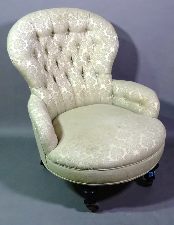 A 19th century button back upholstered chair on ebonised supports.   G8