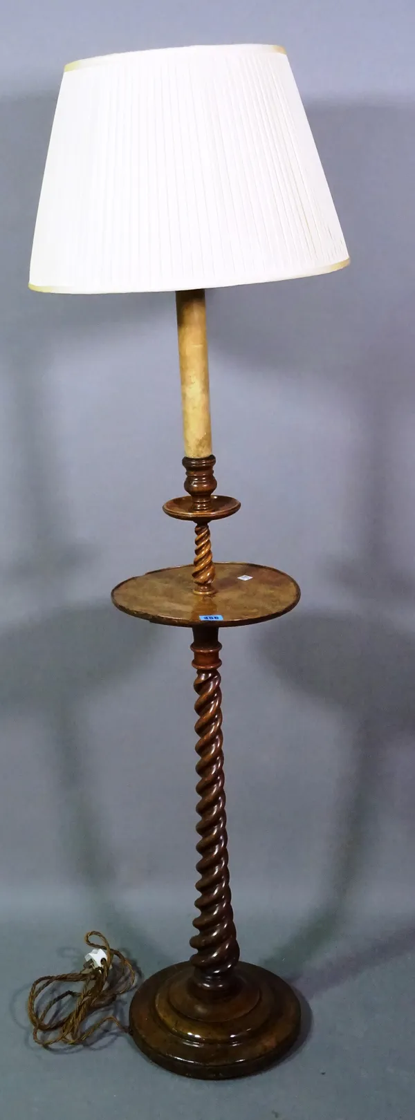 A 19th century walnut standard lamp with spiral turned column on circular base, 85cm high.   D5