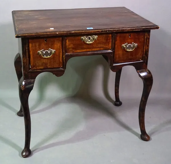 An early 18th century mahogany lowboy, the moulded top above three drawers, with cabriole legs and pad feet, 69cm wide x 76cm high x 52cm deep.   C4