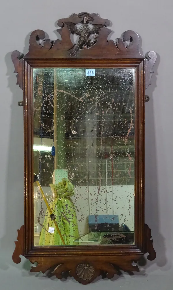 A George III mahogany fret cut wall mirror, the pediment crested with gilded ho ho bird, 86cm high 47cm wide.    F5