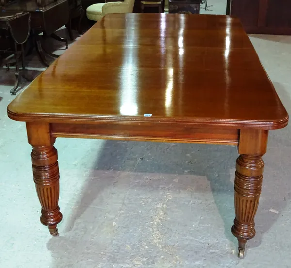 A Victorian mahogany extending dining table on ring turned fluted supports, 136cm long x 75cm high x 234cm fully extended and two leaves.   F8